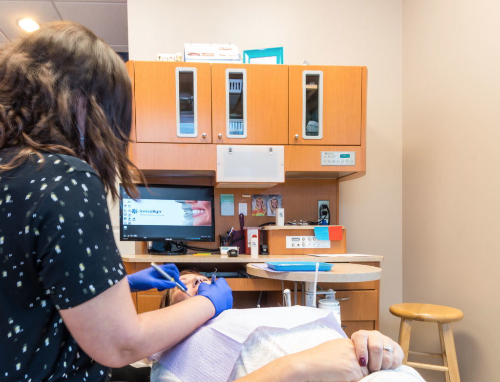 Hygienist doing an exam on a dentures treatment patient to verify the fit for maximum comfort. 
