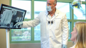 Dr. Annicchiarico reviewing a dental x-ray with a patient
