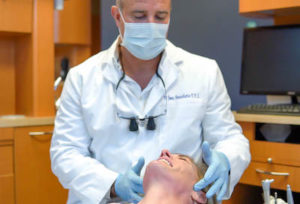 Dr. Annicchiarico discussing cosmetic dentistry options with a patient at his practice A Glamorous Smile in Trinity, FL