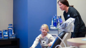 young patient hopping in the dental chair at A Glamorous Smile