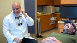 Dr. Annicchiarico talking with a patient during a dental check up